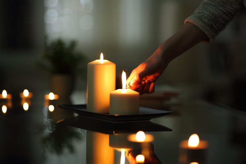Lighting candles in the home at night.