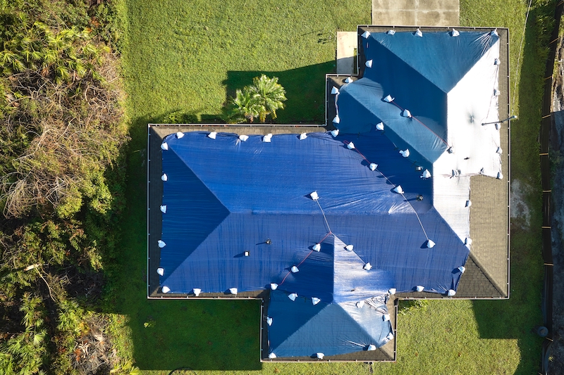 Aerial view of roof tarp covering home