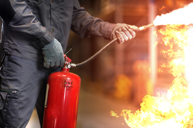 Man using fire extinguisher