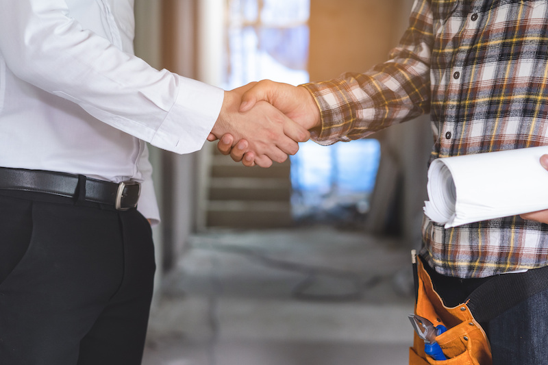 Shaking hands with a contractor for home renovation